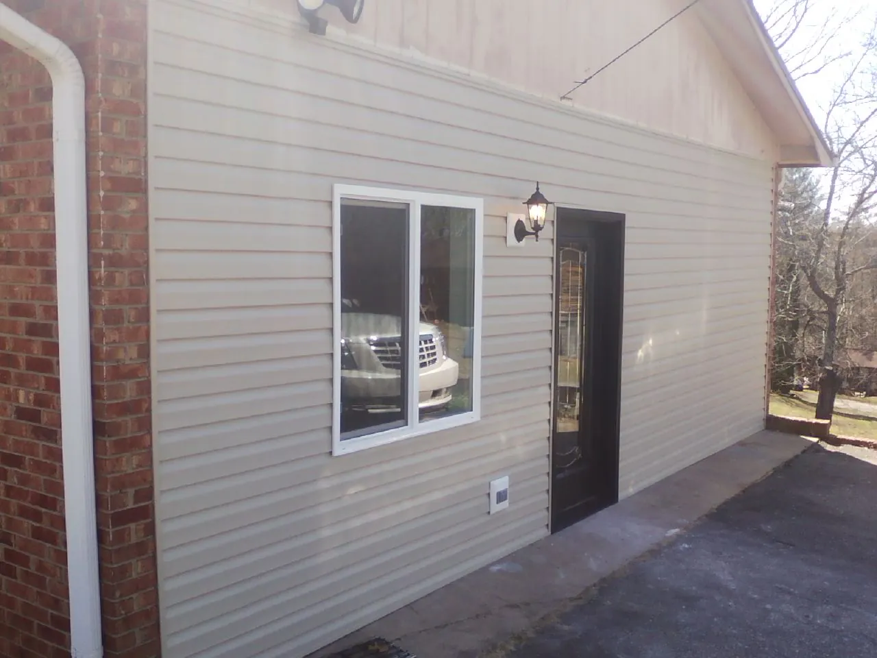 New vinyl siding and entry door on a room addition in Shelbyville