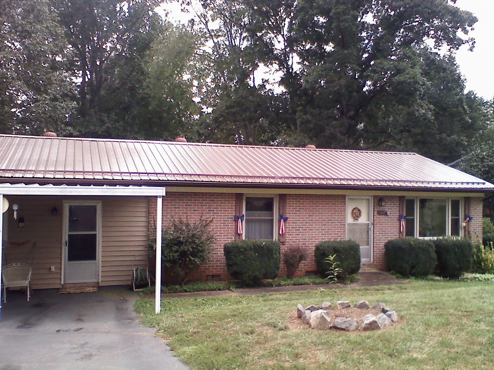Bronze metal roof and carport on a brick ranch home — Roof Repair work by our crew in Shelbyville